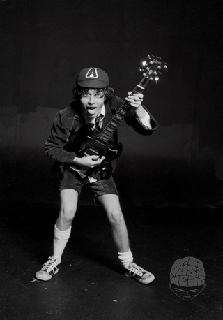 Angus Young, AC/DC, London, 1976, by Michael Putland